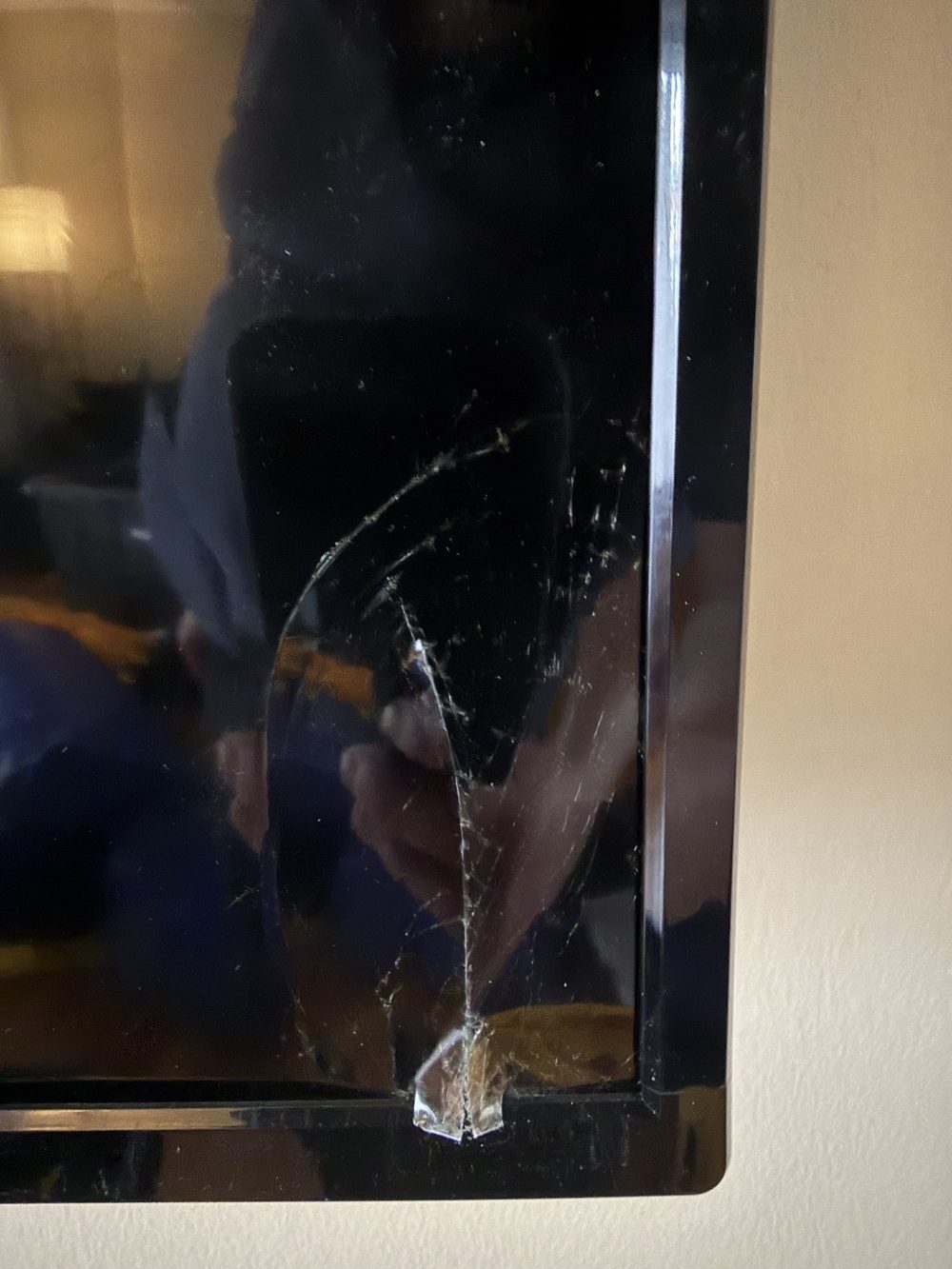 Close-up of the 72-inch TV showing a long crack running down the right side of the screen panel near the bezel